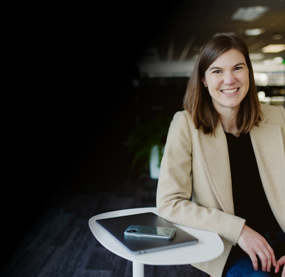 Professional woman with closed laptop smiling