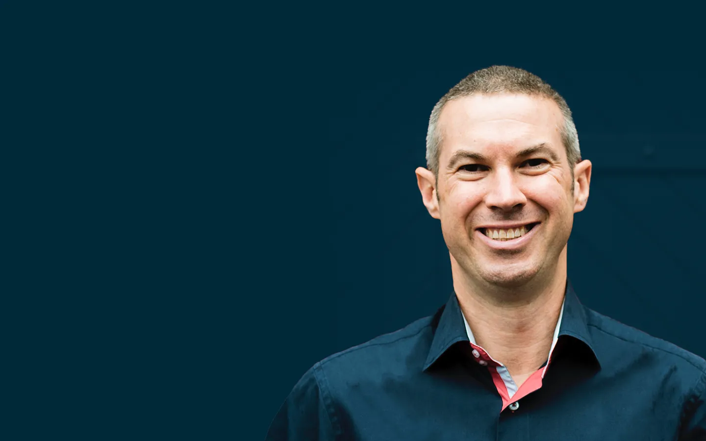 Chief Experience Officer, whiteGREY, man smiling wearing a blue collared button down