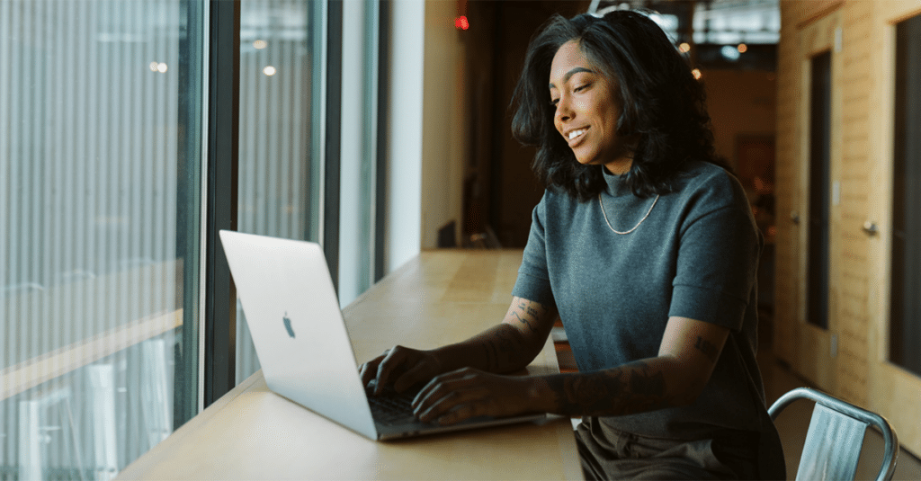 Woman working at laptop in an office.